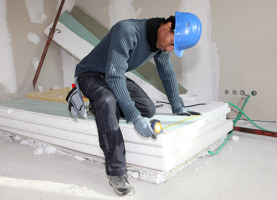 Worker Measuring a Drywall